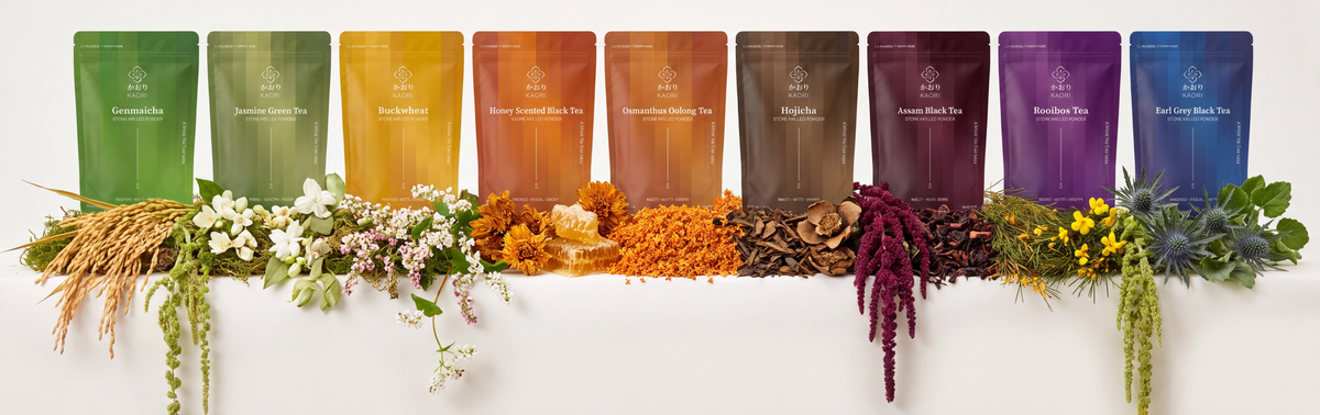 The Kaori teas in a row, each pouch standing above the leaf, flower or grain it is made from