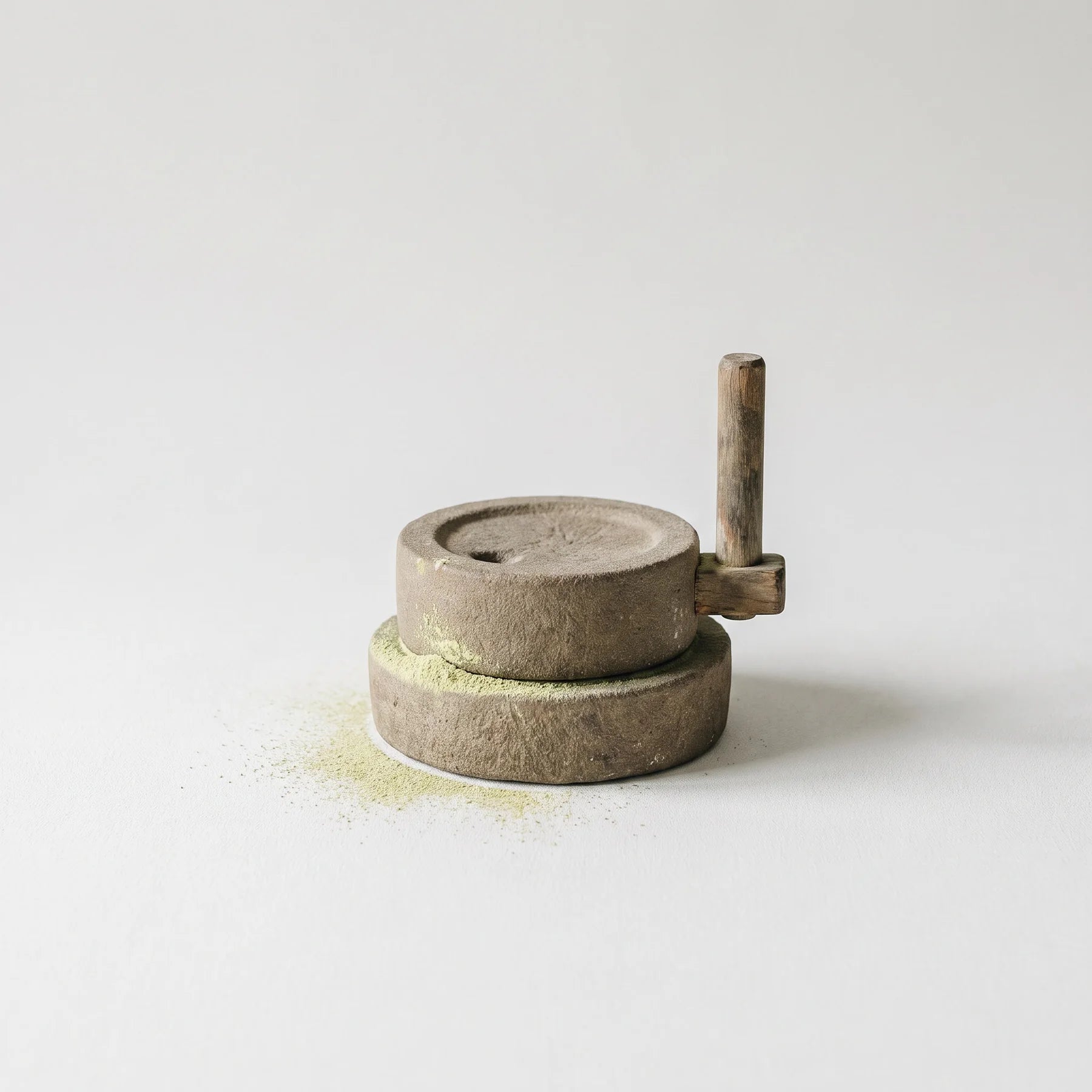 A mill, with tea powder gathering at its lip